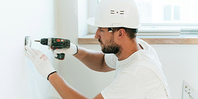 construction worker installing electrical outlet